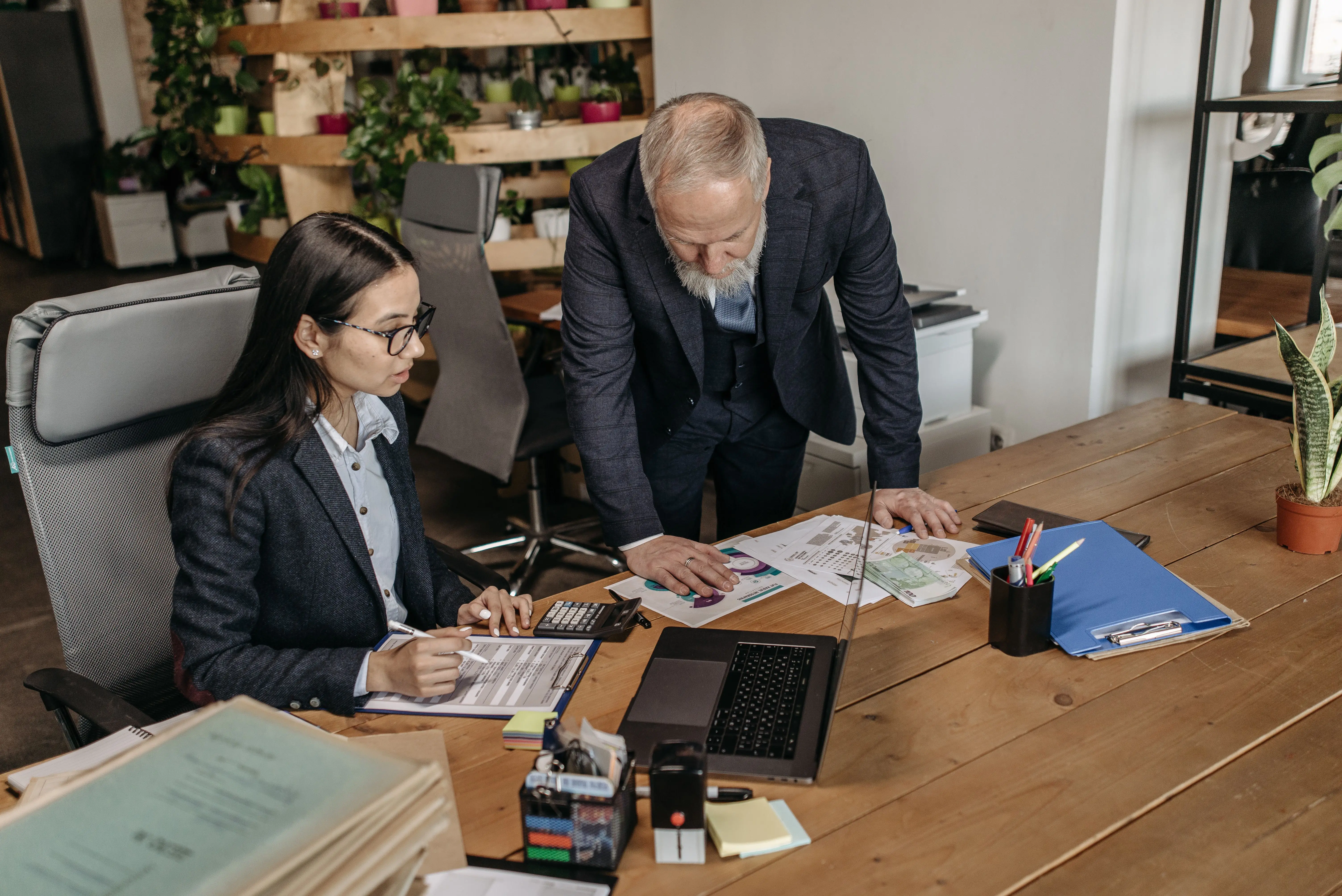 Two coworkers talking in an office setting representing salary transparency and financial revelation