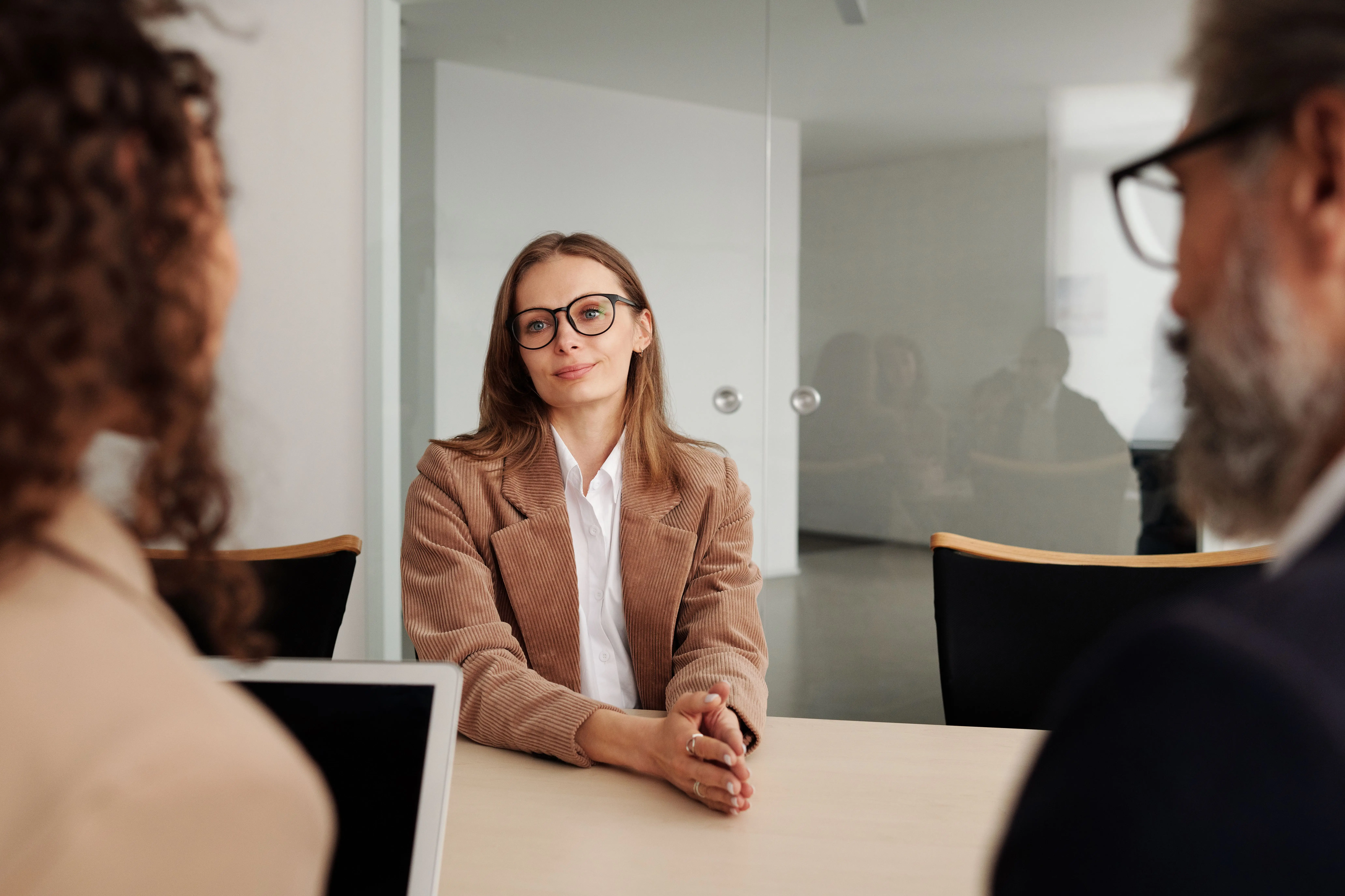 Confident job applicant maintaining eye contact with a diverse corporate interview panel